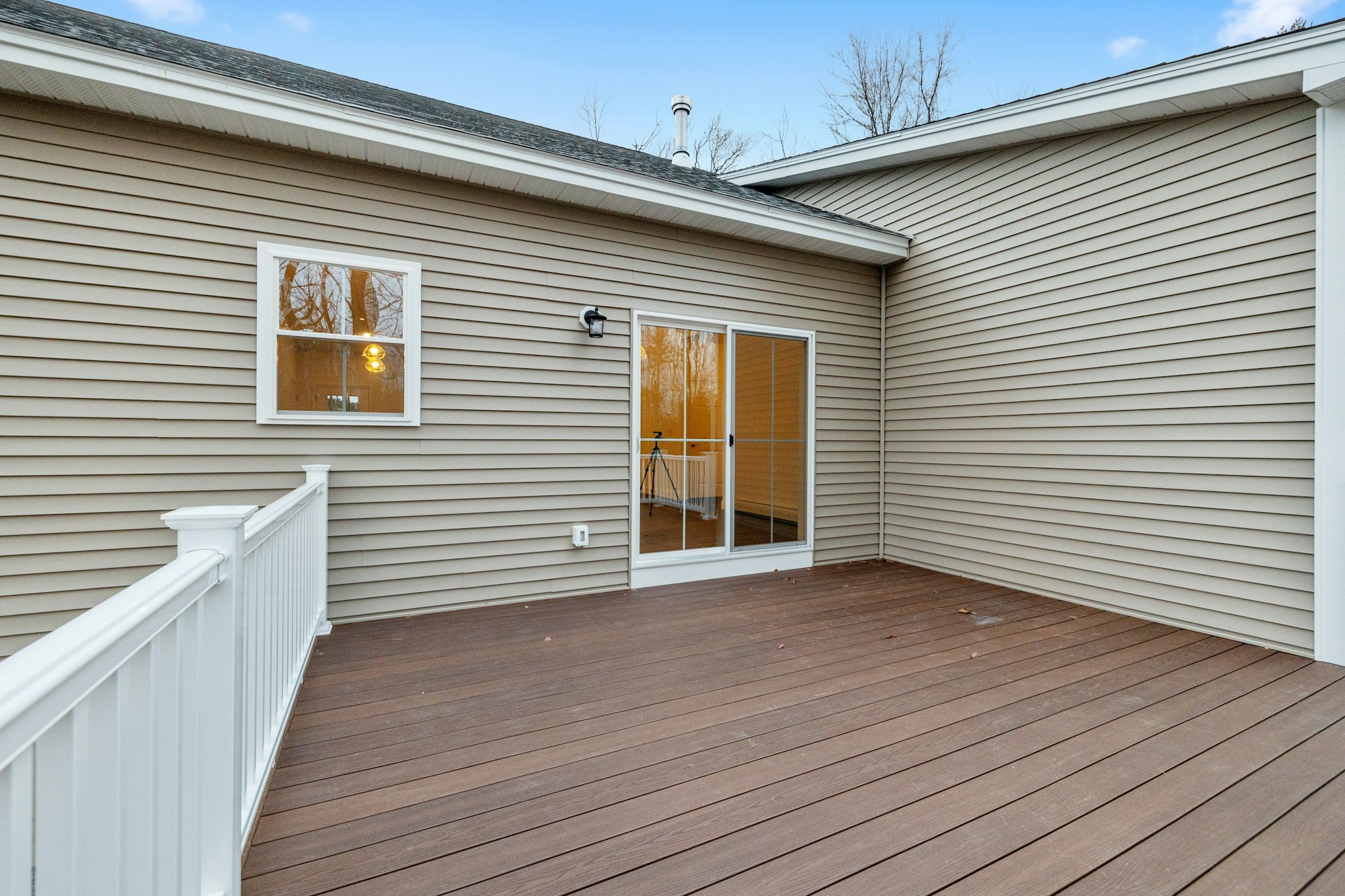 Contemporary and modern ranch-style house in the suburbs, and the decking boards of the porch